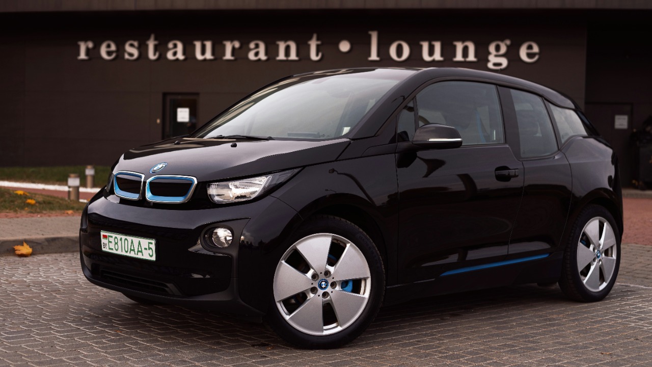 Image Credit: a black car parked outside a building — Vitali Adutskevich