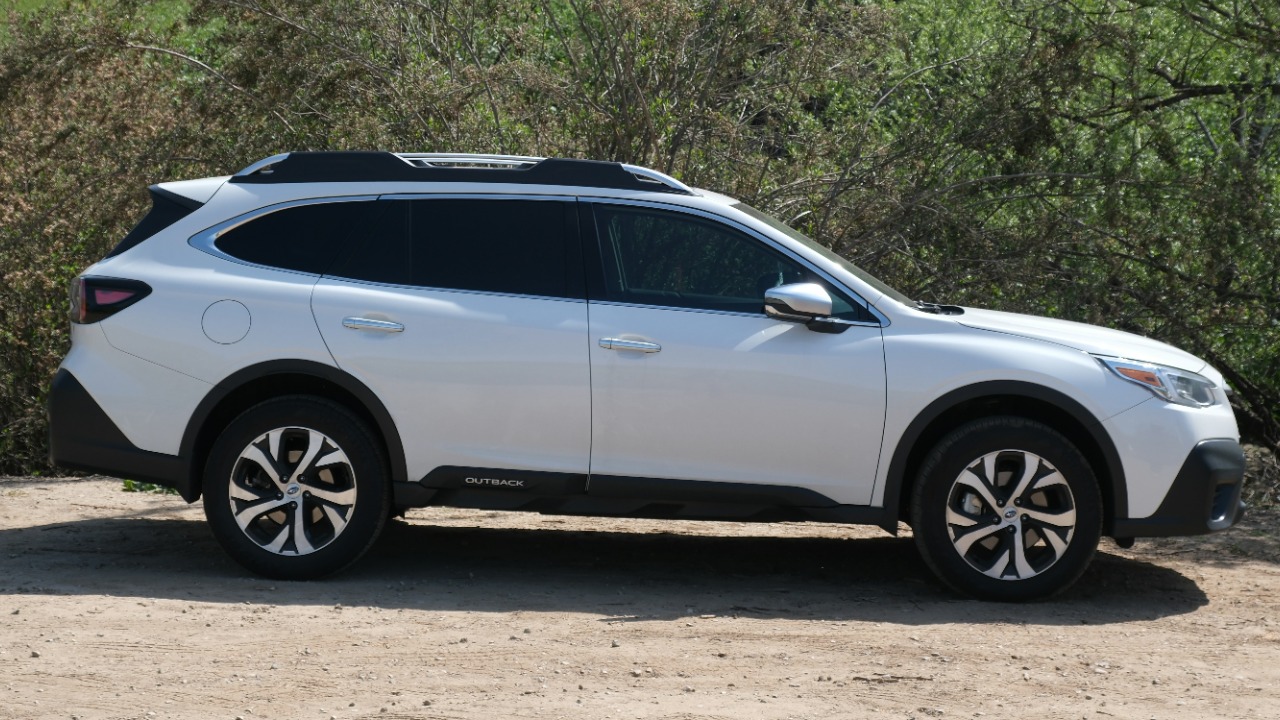 Image Credit: a white car parked in front of a lush green hillside — Rafael Campos