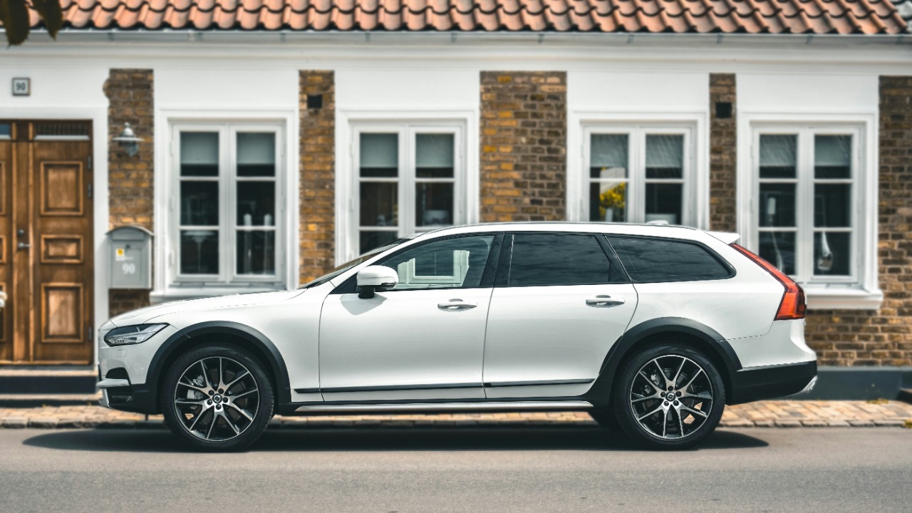 Image Credit: a white volvo car parked in front of a house — CALITORE