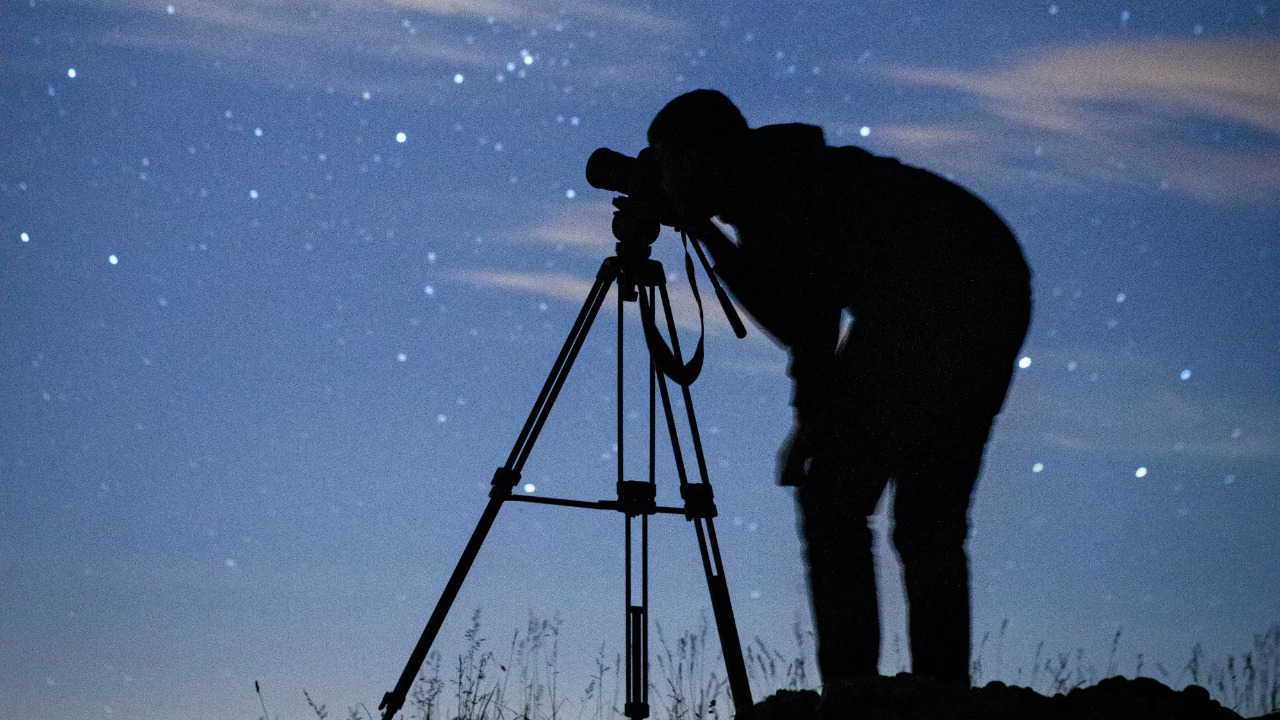 Image Credit: silhouette of man standing under starry night — Saajithan Thayaparan