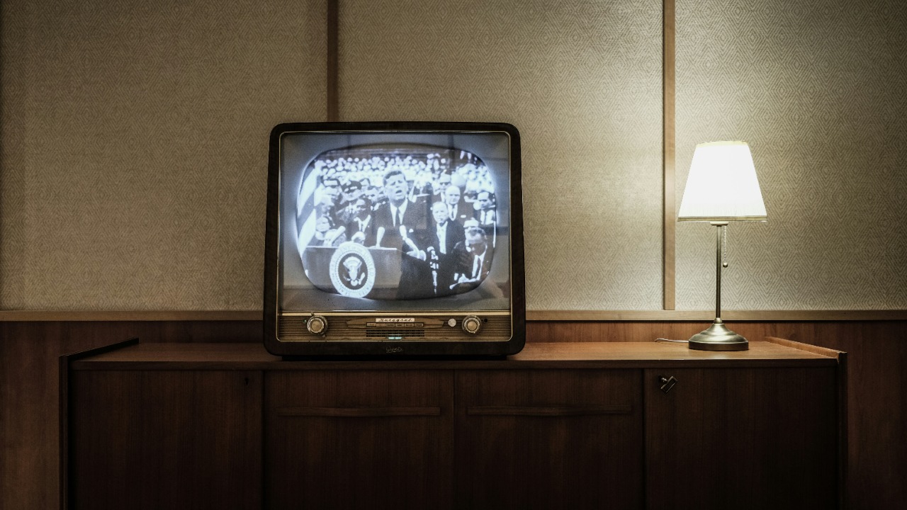 Image Credit: vintage black CRT TV turned-on near lighted table lamp — Lucrezia Carnelos