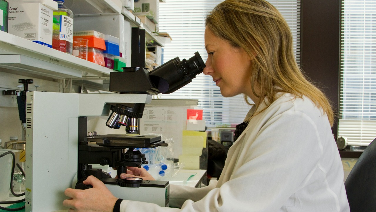 Image Credit: woman in white coat holding black dslr camera — National Cancer Institute