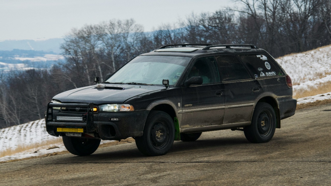 Image Credit: A rugged black subaru station wagon travels a road. — Paul Esch-Laurent