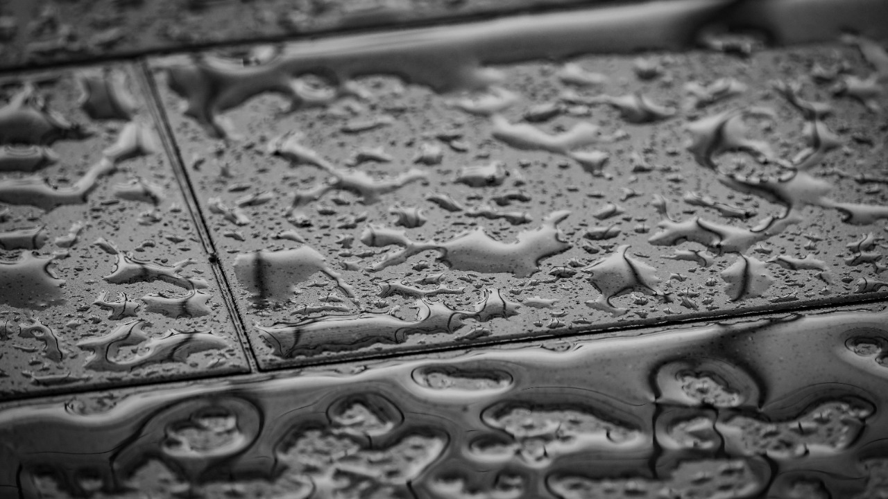 Image Credit: grayscale photo of water droplets on concrete surface — Francesco Ungaro