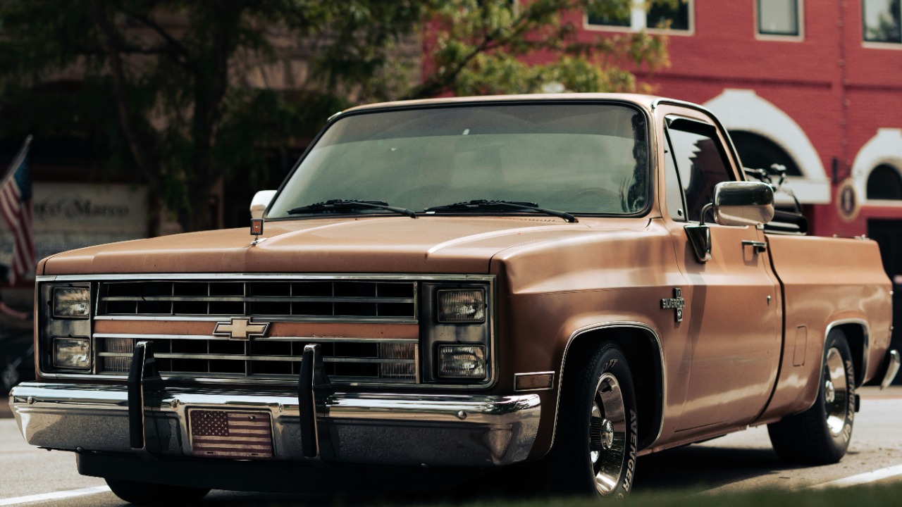 a brown truck parked in front of a red building — Gregory Brainard