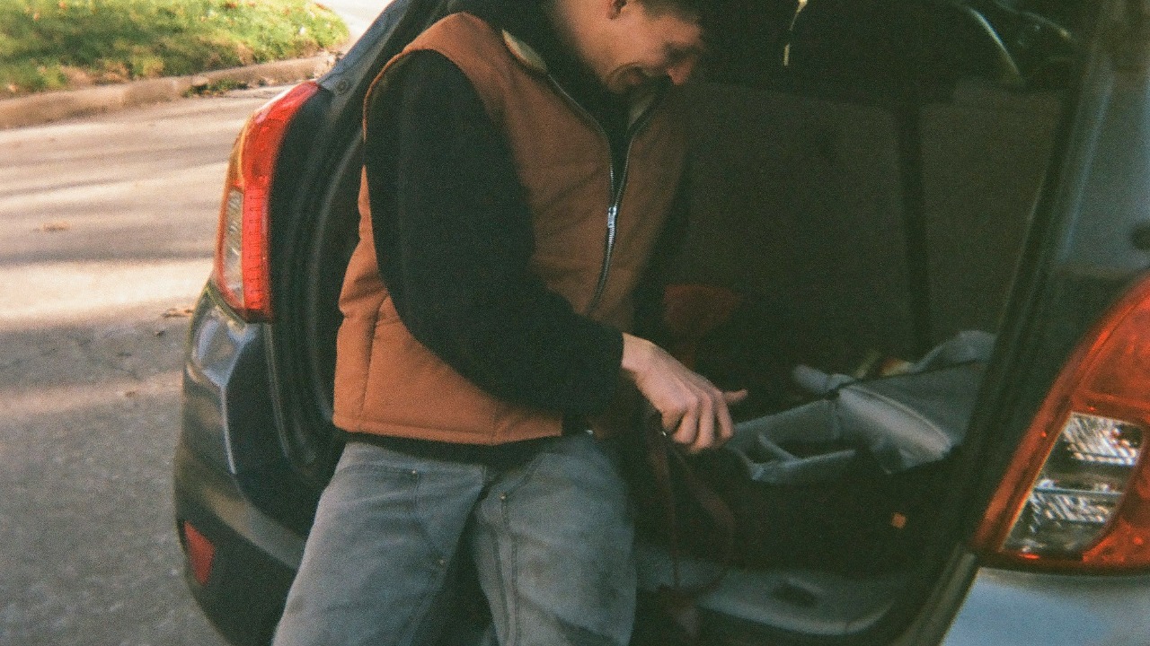 Image Credit: man in black jacket sitting on black car — Parker Coffman
