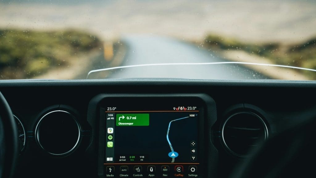 the dashboard of a car with a gps device — Adam Kenton