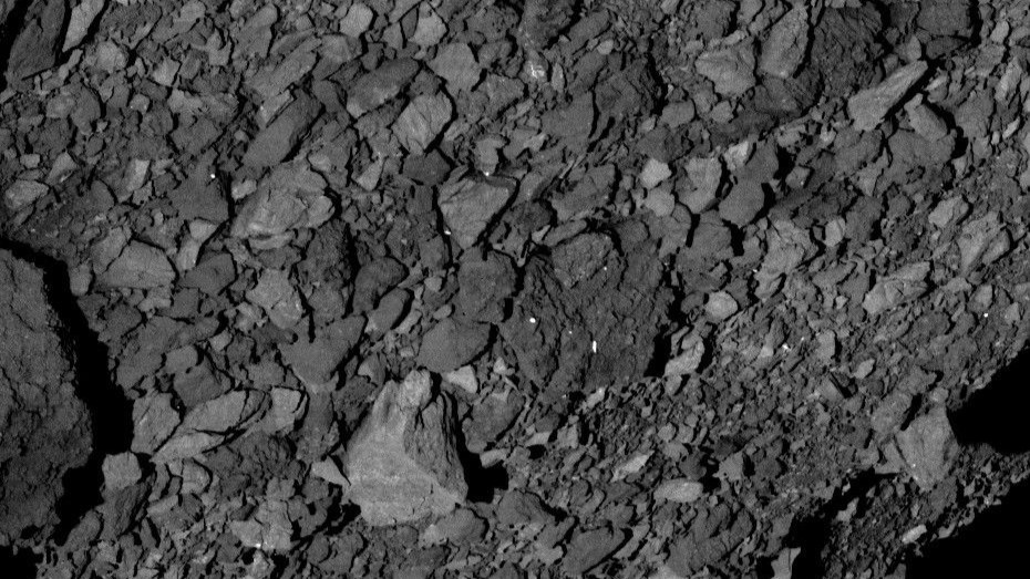 This image shows a view across asteroid Bennu’s southern hemisphere and into space, and it demonstrates the number and distribution of boulders across Bennu’s surface. The image was obtained on March 7, 2019, by the PolyCam camera on NASA’s OSIRIS-REx spacecraft from a distance of about 3 miles (5 kilometers). The large, light-colored boulder in the center of the image is about 24 feet (7.4 meters) wide, which is roughly half the width of a basketball court.